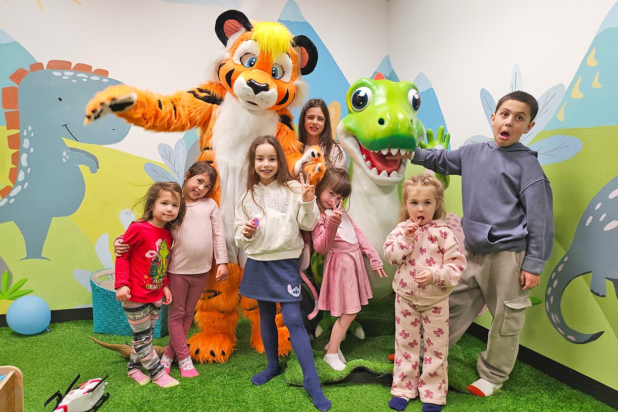 Dinosaur and mascot with children